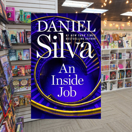An Inside Job by Daniel Silva — actual cover on The Perk bookstore background