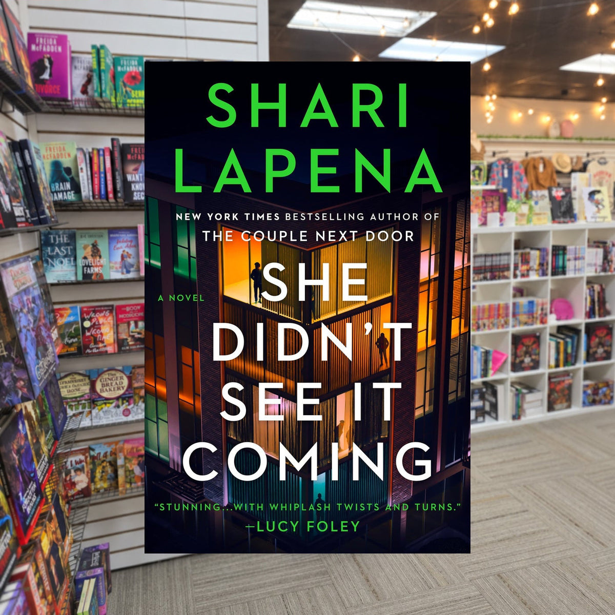 She Didn't See It Coming by Shari Lapena — actual cover on The Perk bookstore background