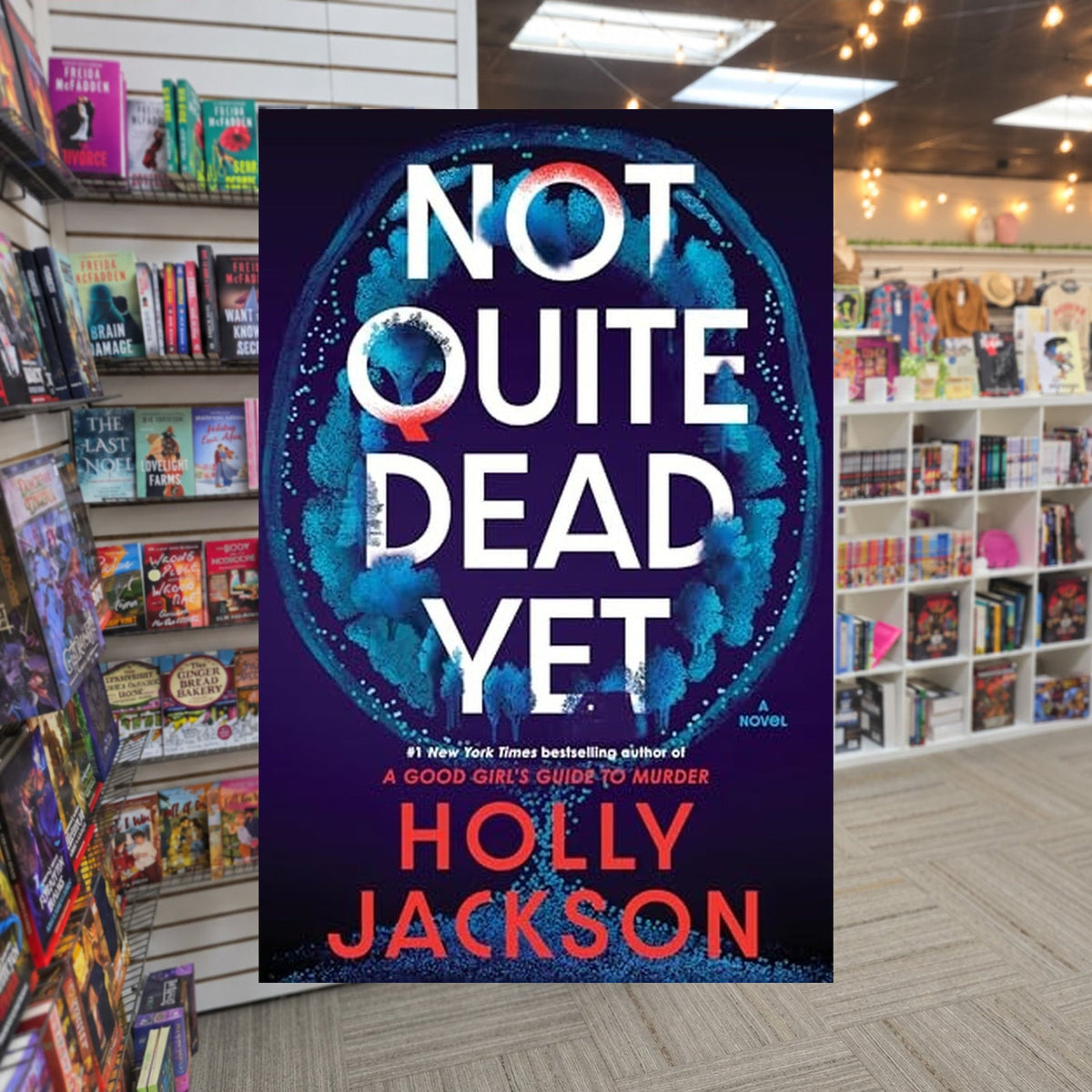 Not Quite Dead Yet by Holly Jackson — actual cover on The Perk bookstore background