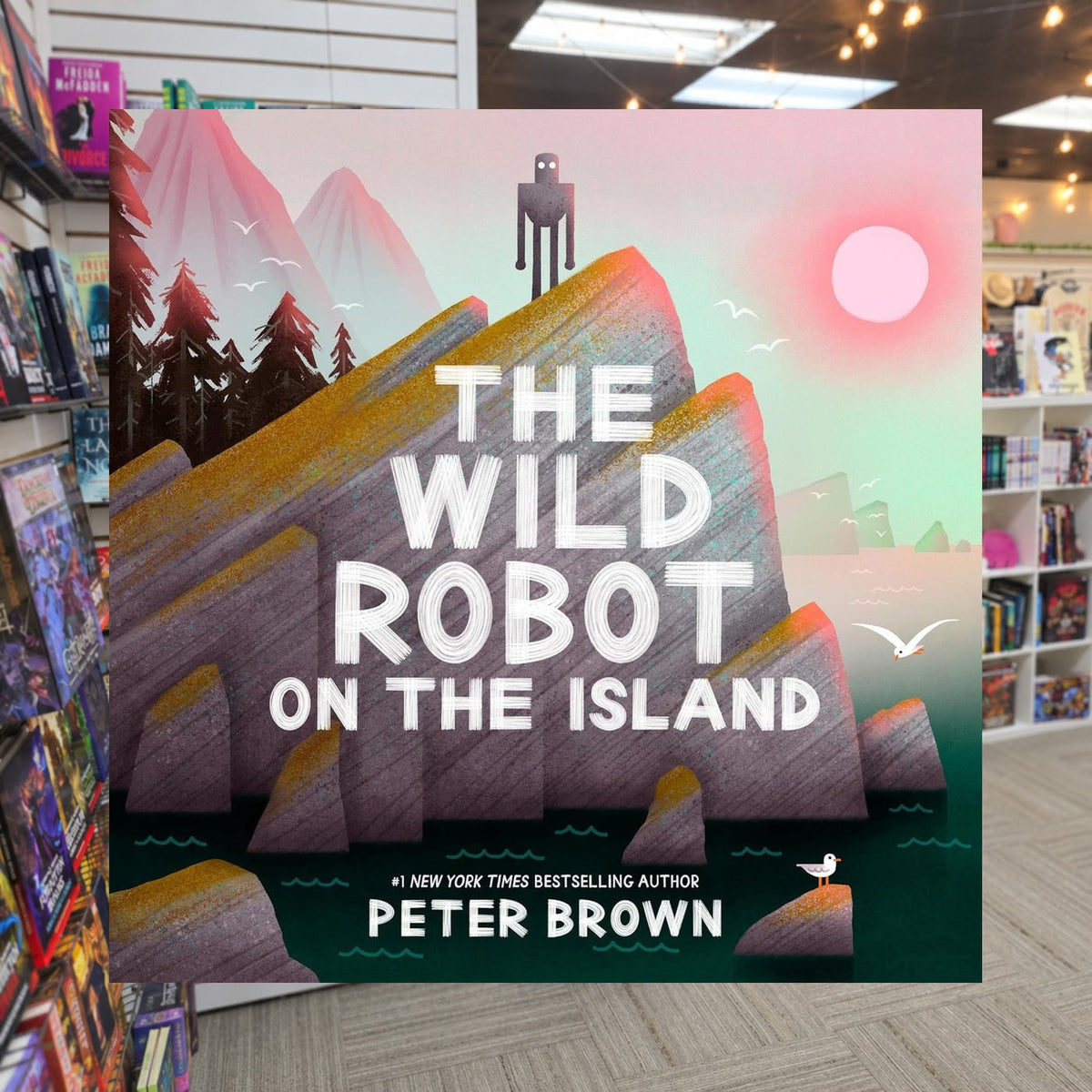 The Wild Robot on the Island by Peter Brown — actual cover on The Perk bookstore background