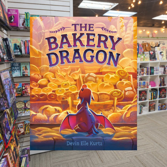 The Bakery Dragon by Devin Elle Kurtz — actual cover on The Perk bookstore background