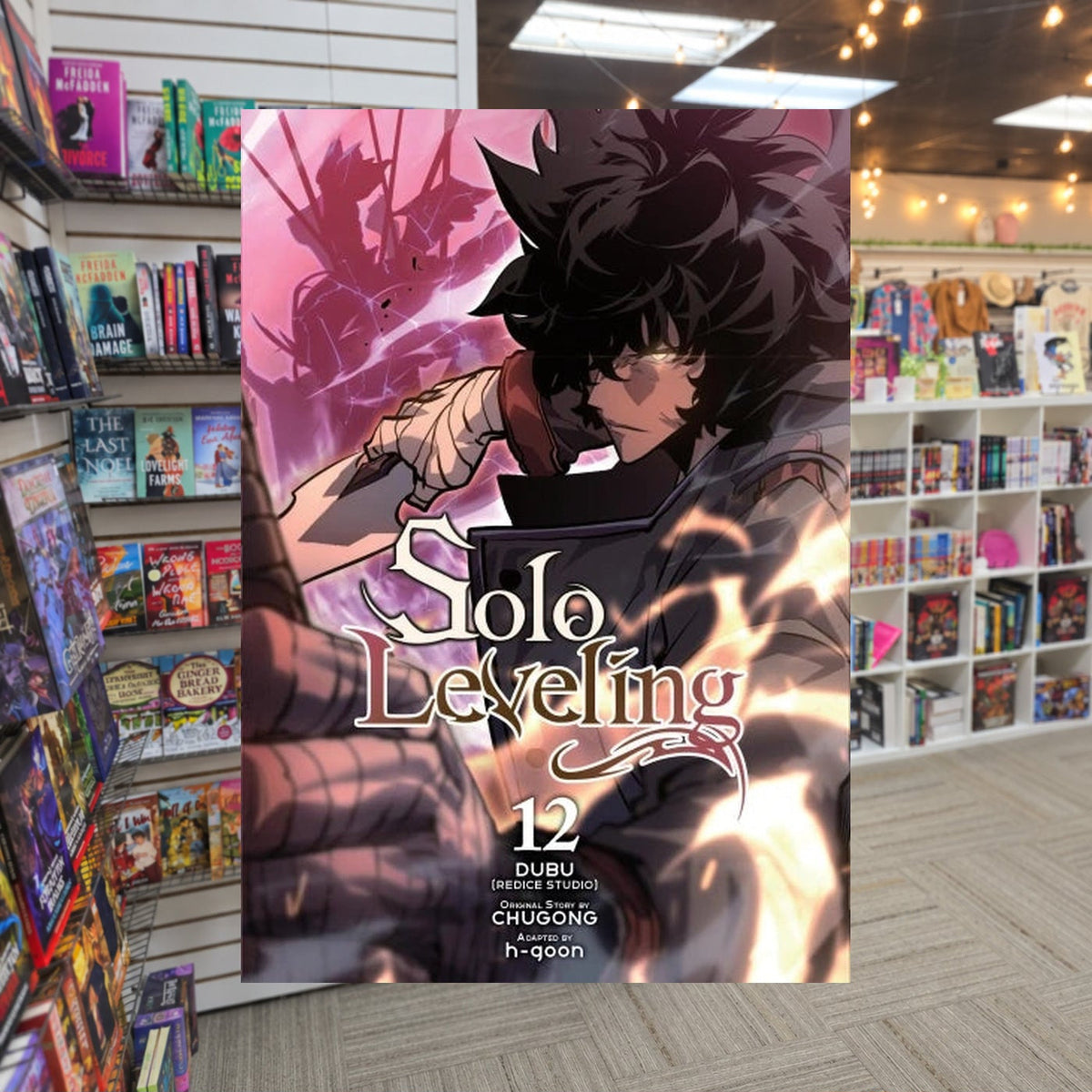 Solo Leveling, Vol. 12 by Chugong — actual cover on The Perk bookstore background