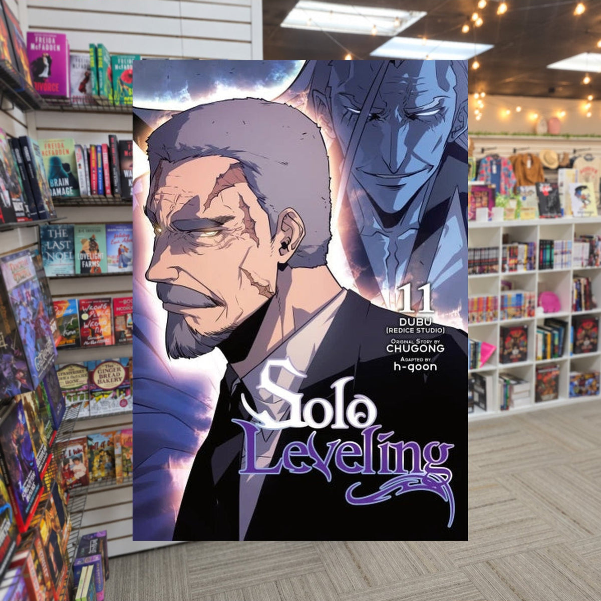 Solo Leveling, Vol. 11 by Chugong — actual cover on The Perk bookstore background