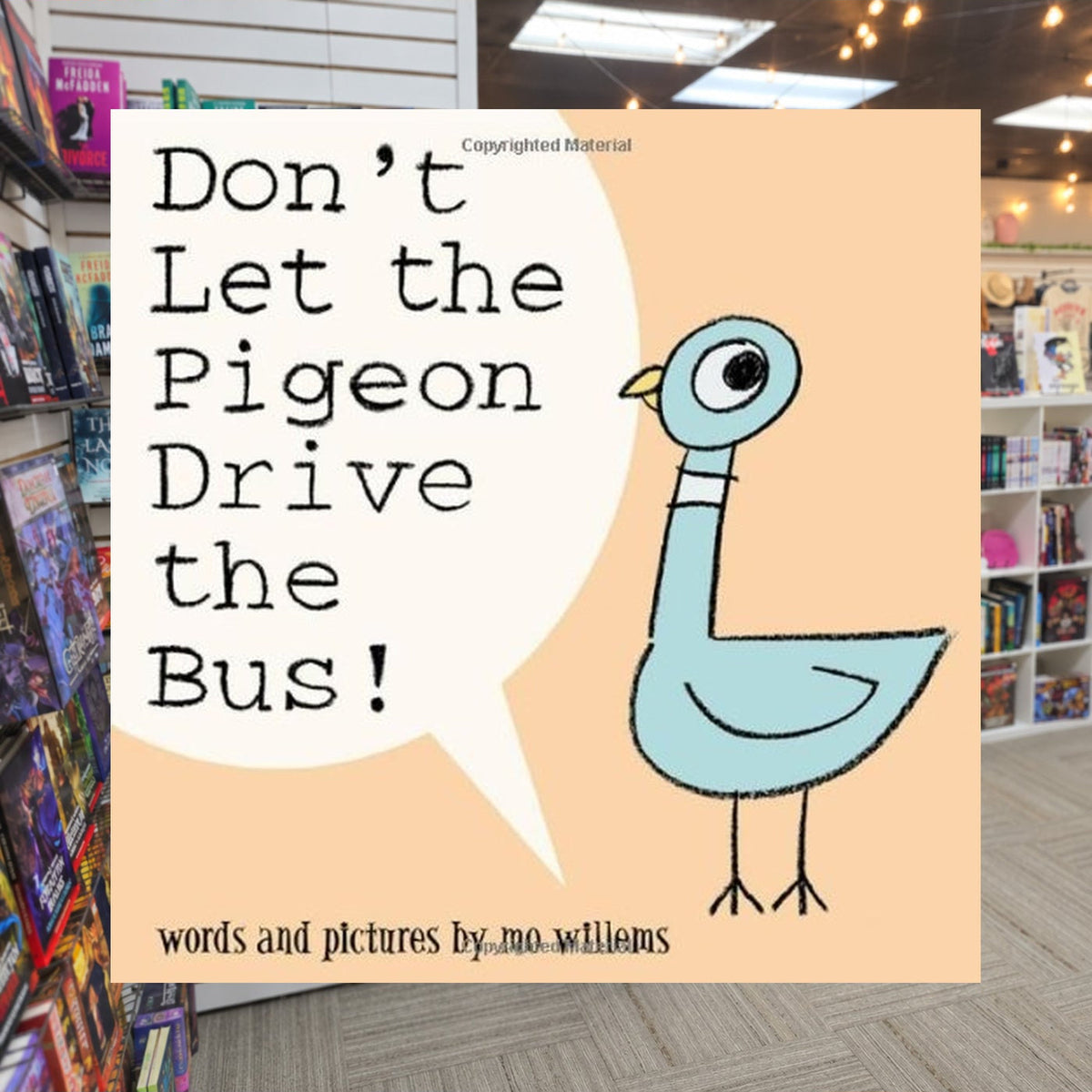 Don't Let the Pigeon Drive the Bus by Mo Willems — actual cover on The Perk bookstore background