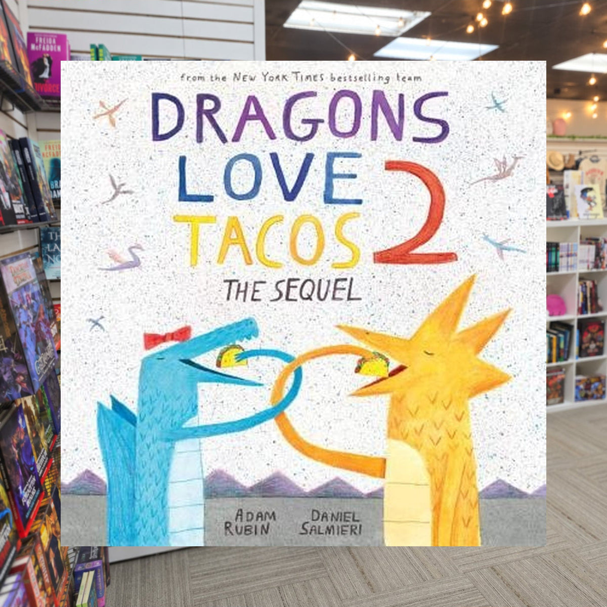 Dragons Love Tacos 2: The Sequel by Adam Rubin — actual cover on The Perk bookstore background