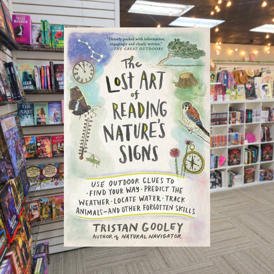 The Lost Art of Reading Nature's Signs by Tristan Gooley — actual cover on The Perk bookstore background