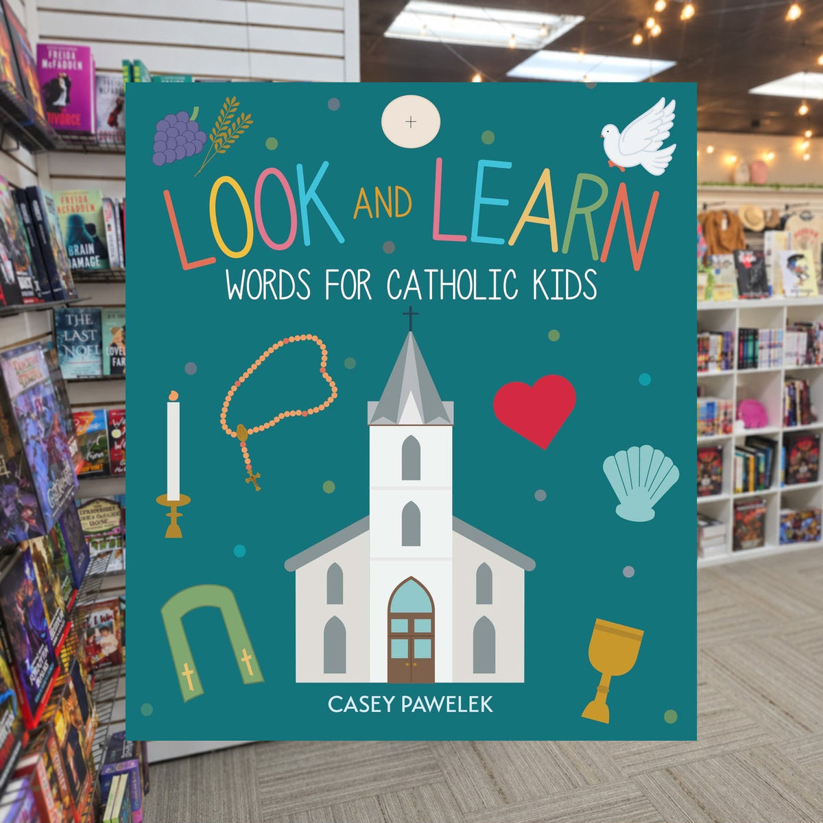 Look and Learn: Words for Catholic Kids by Casey Pawelek — actual cover on The Perk bookstore background