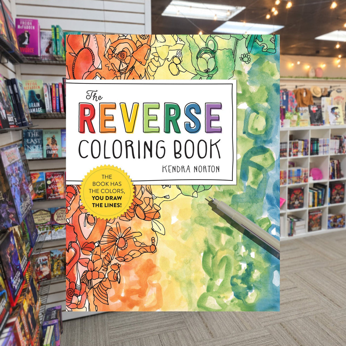 The Reverse Coloring Book by Kendra Norton — actual cover on The Perk bookstore background
