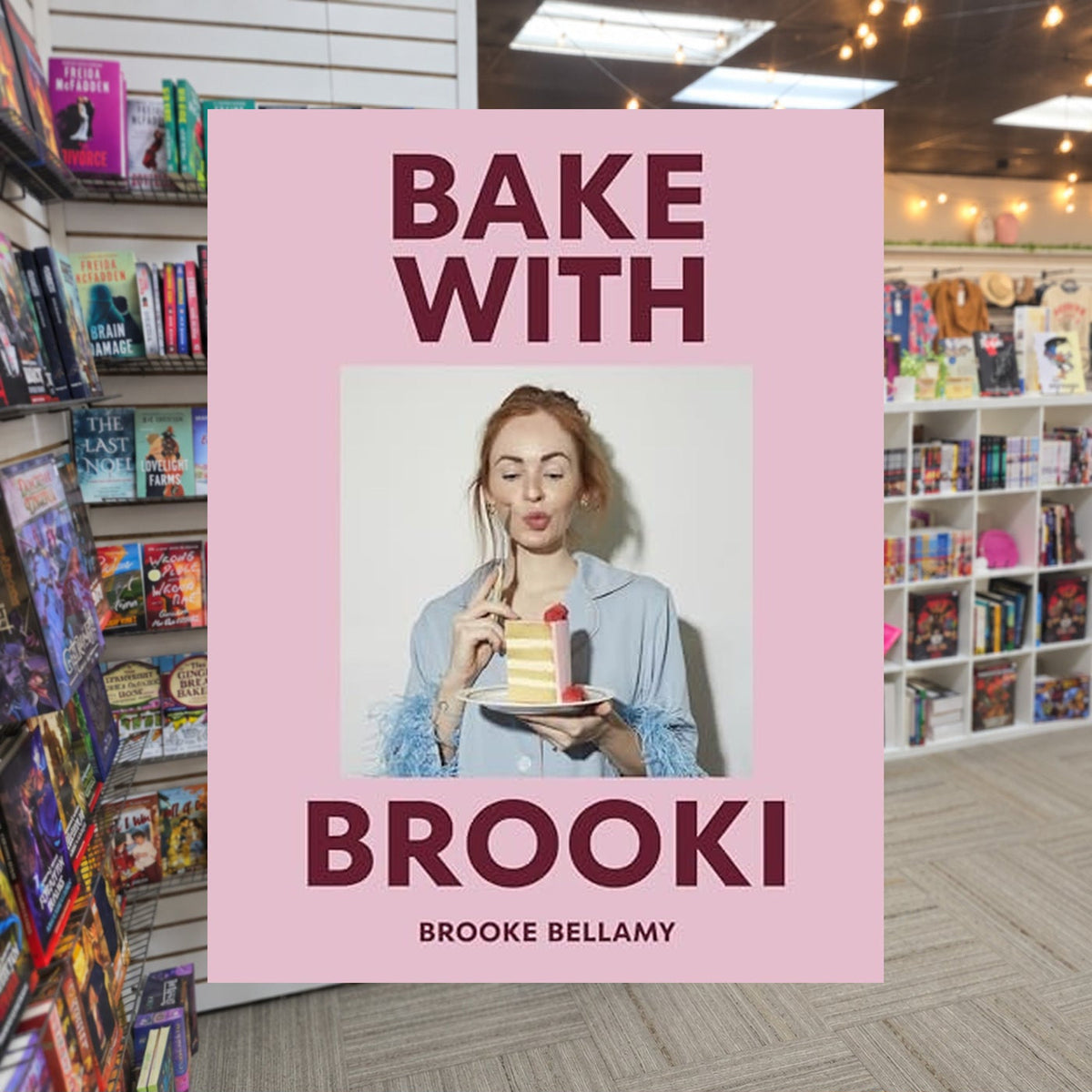 Bake With Brooki by Brooke Bellamy — actual cover on The Perk bookstore background