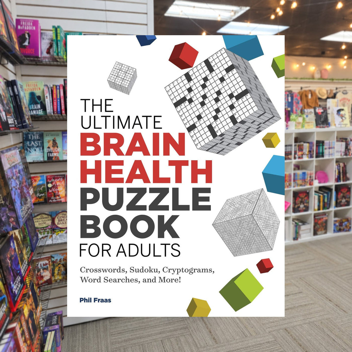 The Ultimate Brain Health Puzzle Book for Adults by Phil Fraas — actual cover on The Perk bookstore background