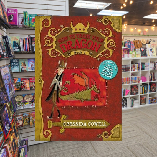 How to Train Your Dragon by Cressida Cowell — actual cover on The Perk bookstore background