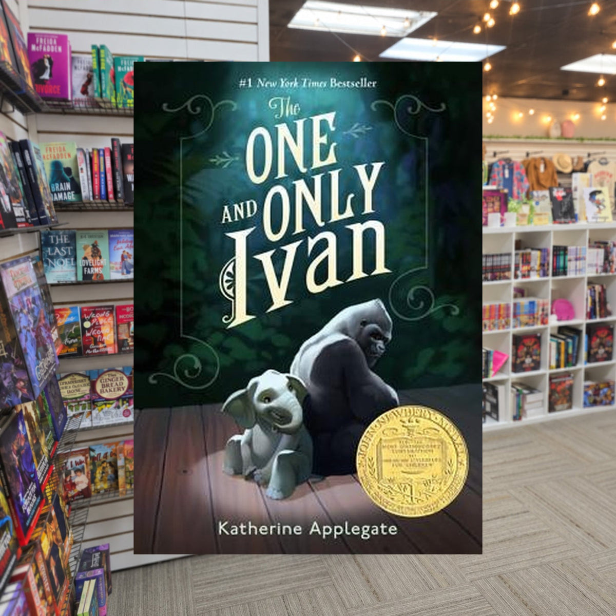 The One and Only Ivan by Katherine Applegate — actual cover on The Perk bookstore background
