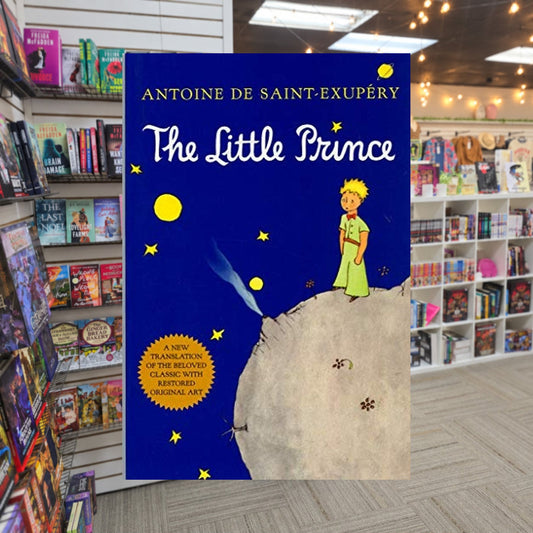 The Little Prince by Antoine de Saint-Exupéry — actual cover on The Perk bookstore background