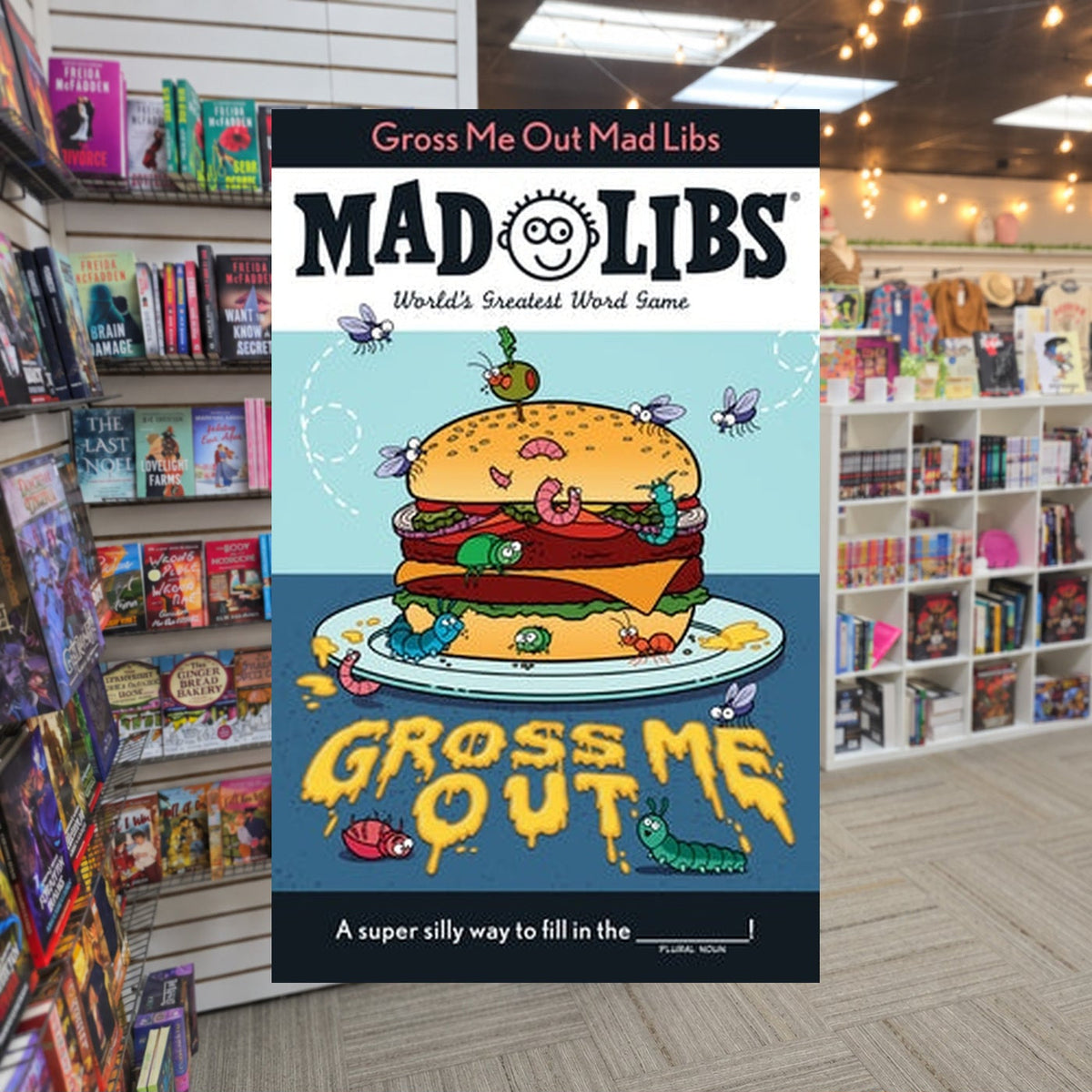 Gross Me Out Mad Libs: World's Greatest Word Game by Gabriella Degennaro — actual cover on The Perk bookstore background