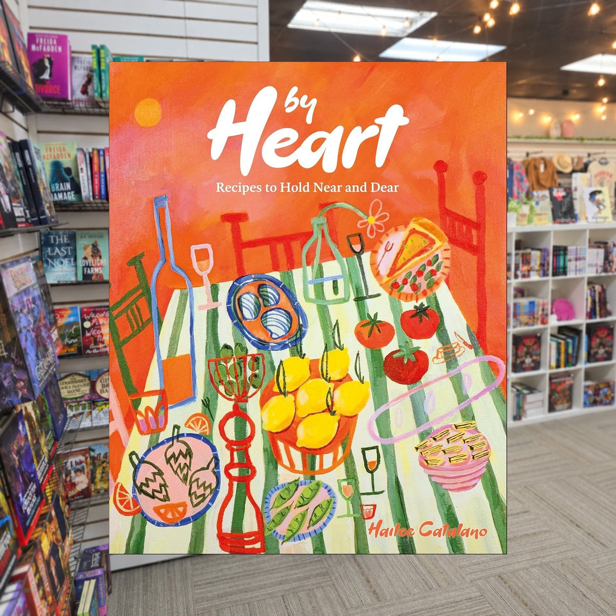 By Heart: Recipes to Hold Near and Dear by Hailee Catalano — actual cover on The Perk bookstore background