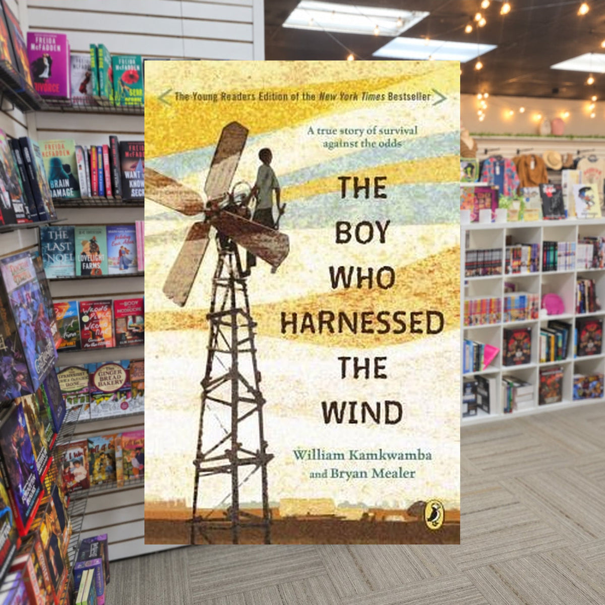 The Boy Who Harnessed the Wind by William Kamkwamba — actual cover on The Perk bookstore background