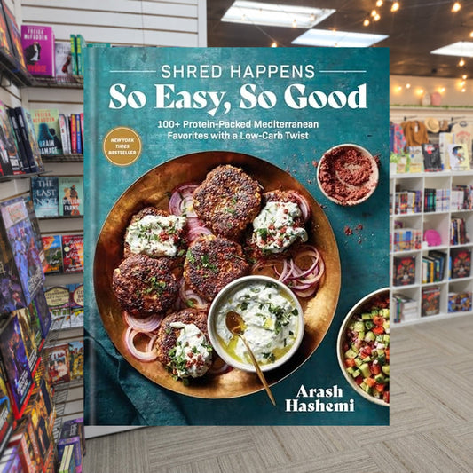 Shred Happens: So Easy, So Good: 100= Protein-Packed Mediterranean Favorites by Arash Hashemi — actual cover on The Perk bookstore background