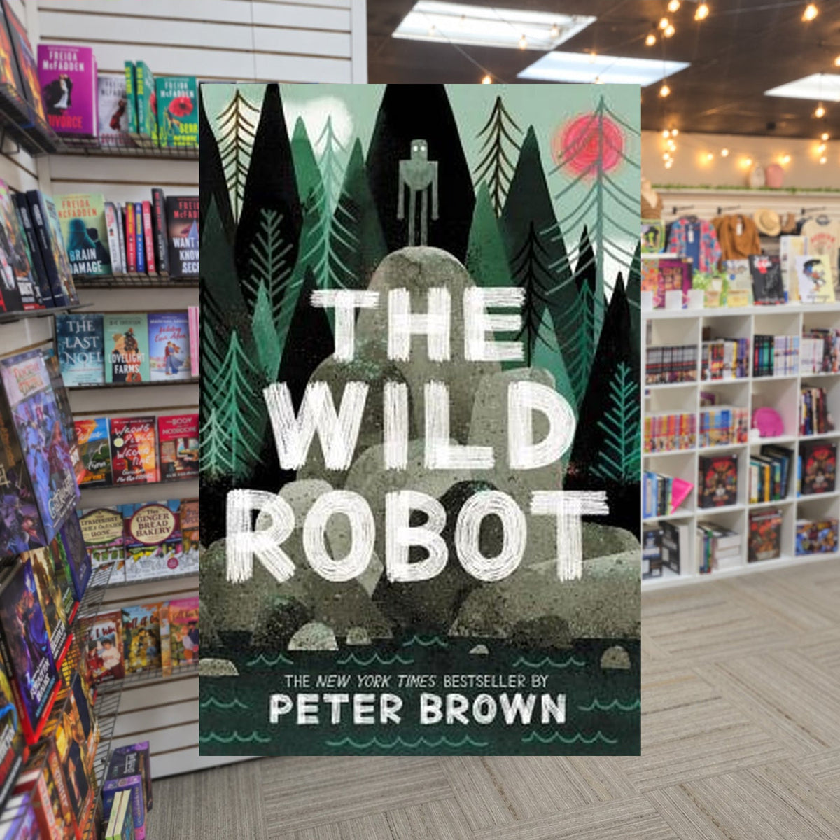 The Wild Robot by Peter Brown — actual cover on The Perk bookstore background