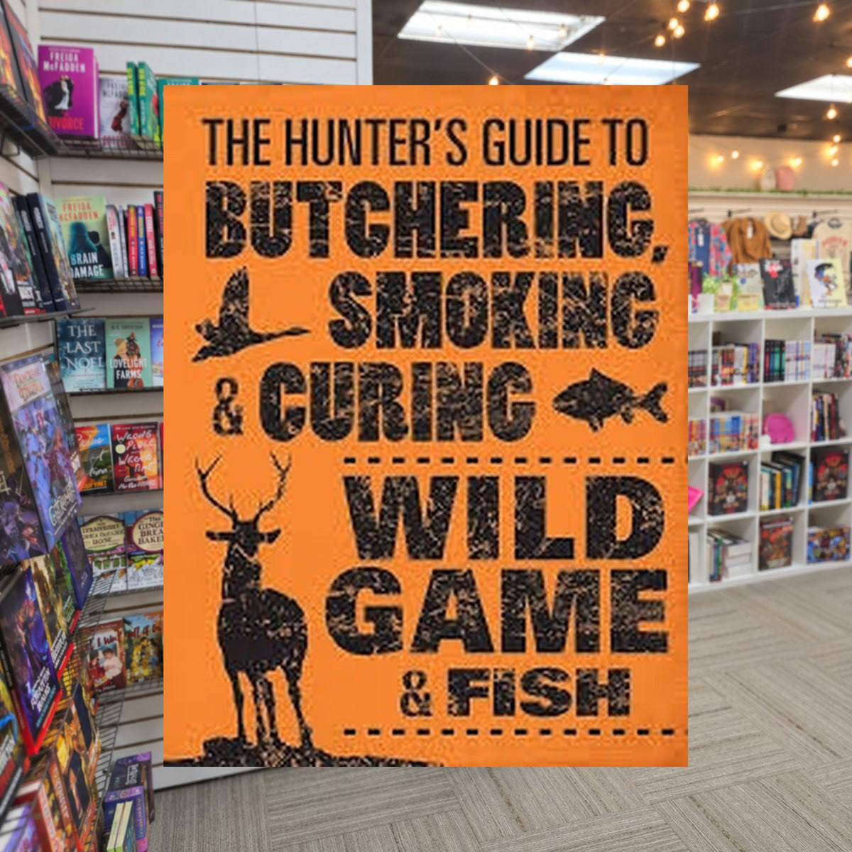 The Hunter's Guide to Butchering, Smoking, and Curing Wild Game and Fish by Philip Hasheider — actual cover on The Perk bookstore background