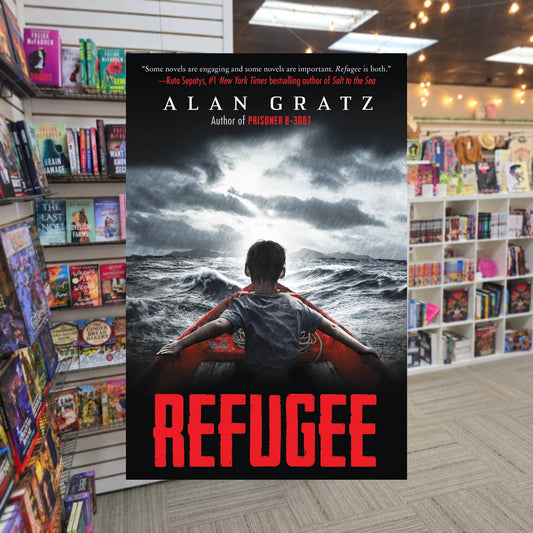 Refugee by Alan Gratz — actual cover on The Perk bookstore background