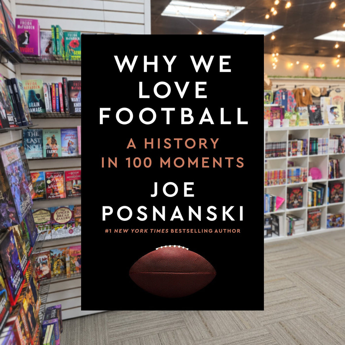 Why We Love Football: A History in 100 Moments — actual cover on The Perk bookstore background