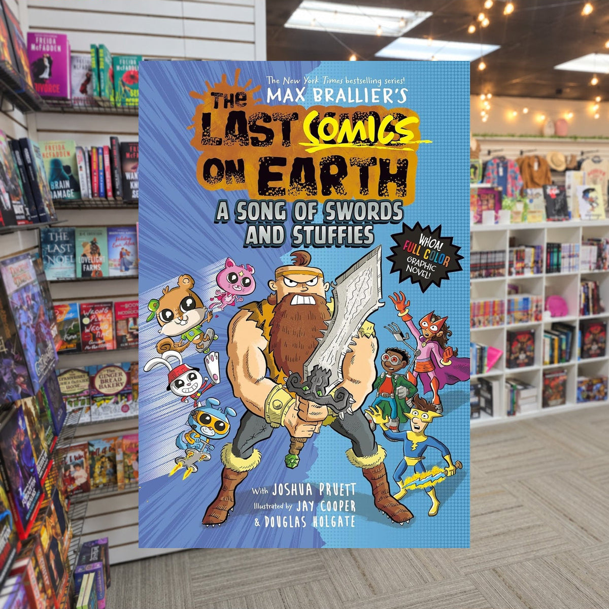 A Song of Swords & Stuffies by Max Brallier — actual cover on The Perk bookstore background