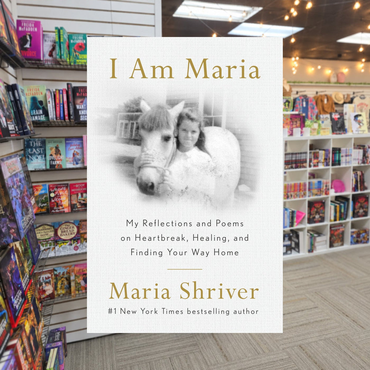 I Am Maria by Maria Shriver — actual cover on The Perk bookstore background