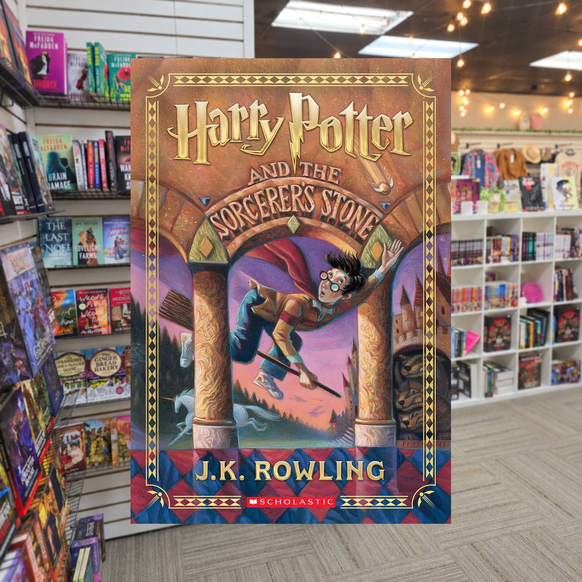 Harry Potter and the Sorcerer's Stone by J.K. Rowling — actual cover on The Perk bookstore background