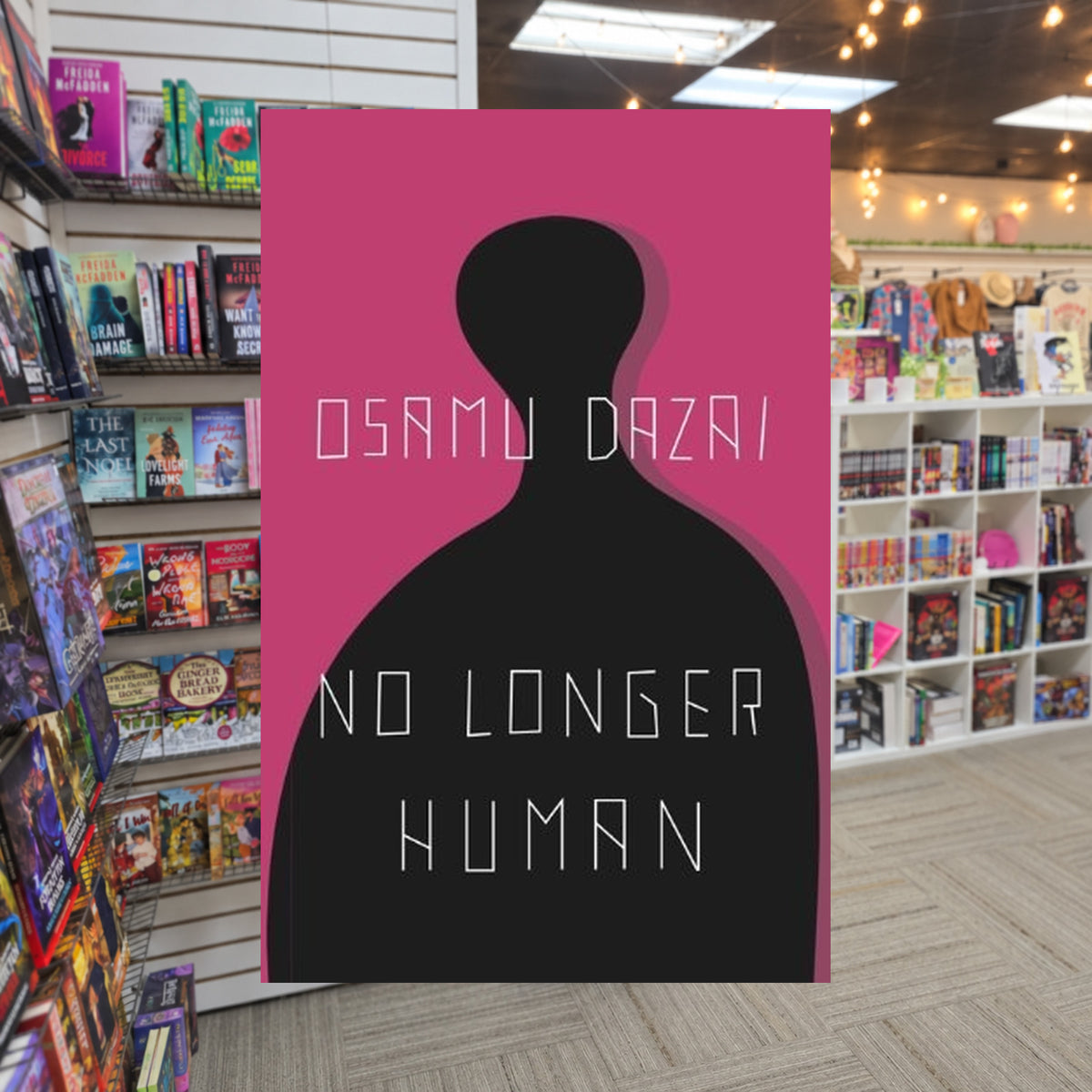 No Longer Human by Osamu Dazai — actual cover on The Perk bookstore background