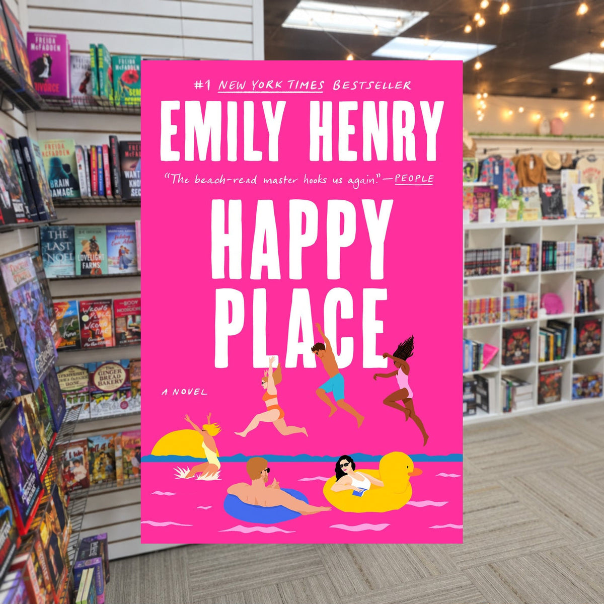 Happy Place by Emily Henry — actual cover on The Perk bookstore background