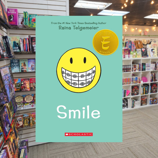 Smile: A Graphic Novel by Raina Telgemeier — actual cover on The Perk bookstore background