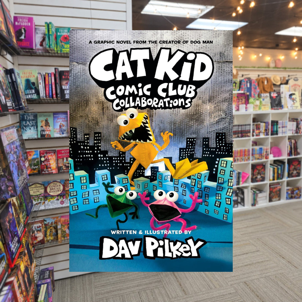 Cat Kid Comic Club: Collaborations by Dav Pilkey — actual cover on The Perk bookstore background