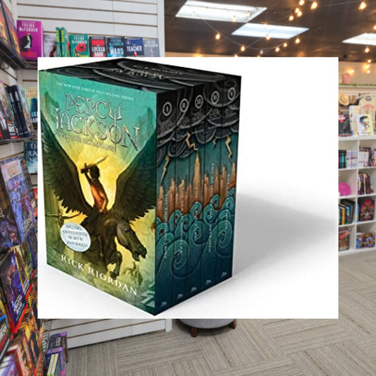 Percy Jackson and the Olympians 5 Book Paperback Boxed Set by Rick Riordan — actual cover on The Perk bookstore background