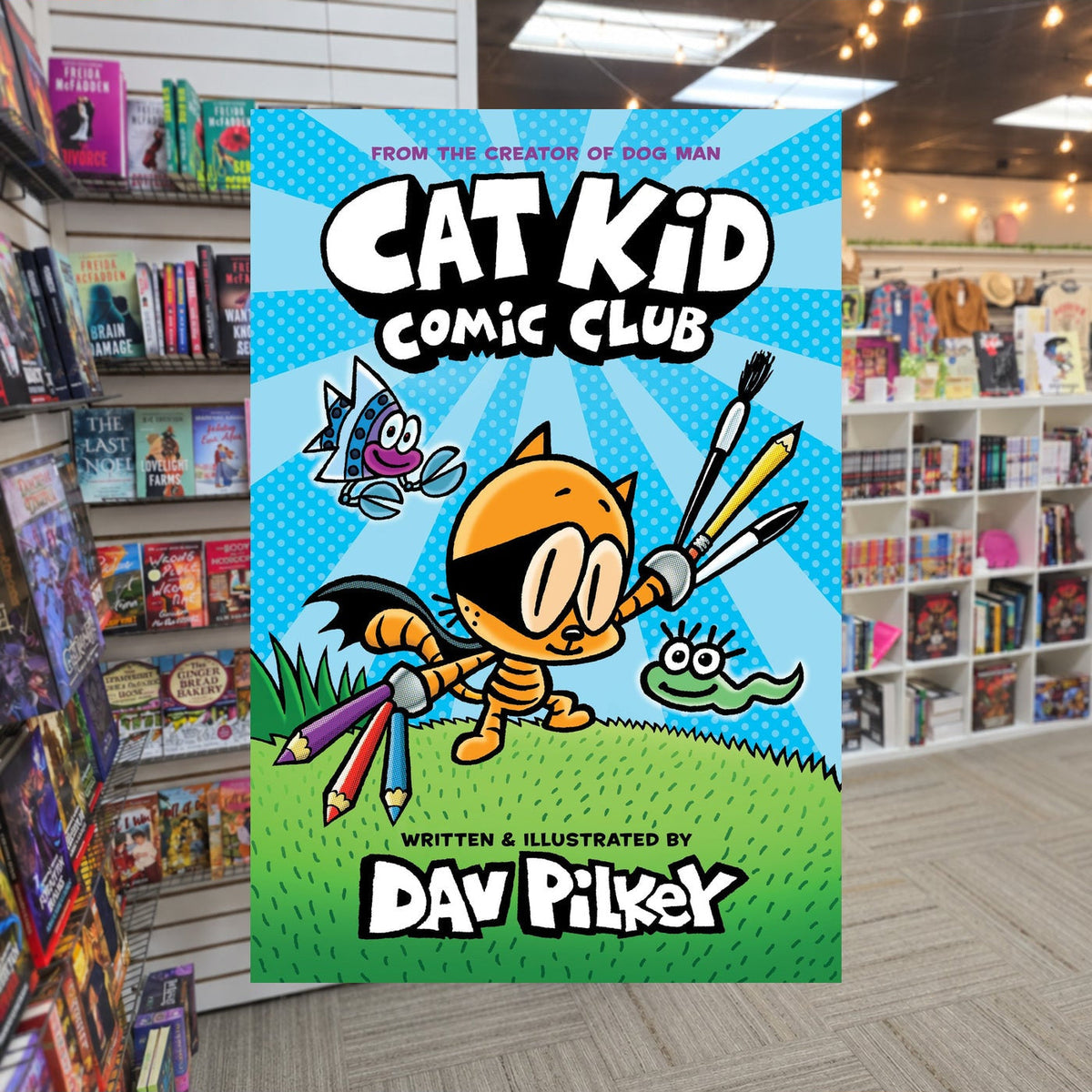 Cat Kid Comic Club: A Graphic Novel by Dav Pilkey — actual cover on The Perk bookstore background