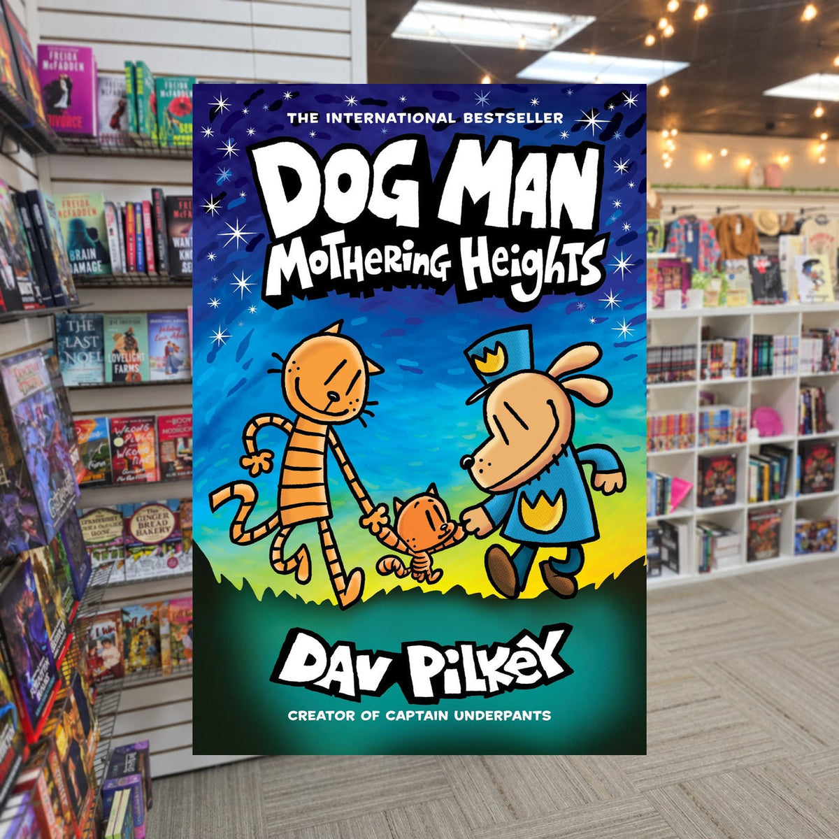 Dog Man: Mothering Heights by  Dav Pilkey — actual cover on The Perk bookstore background
