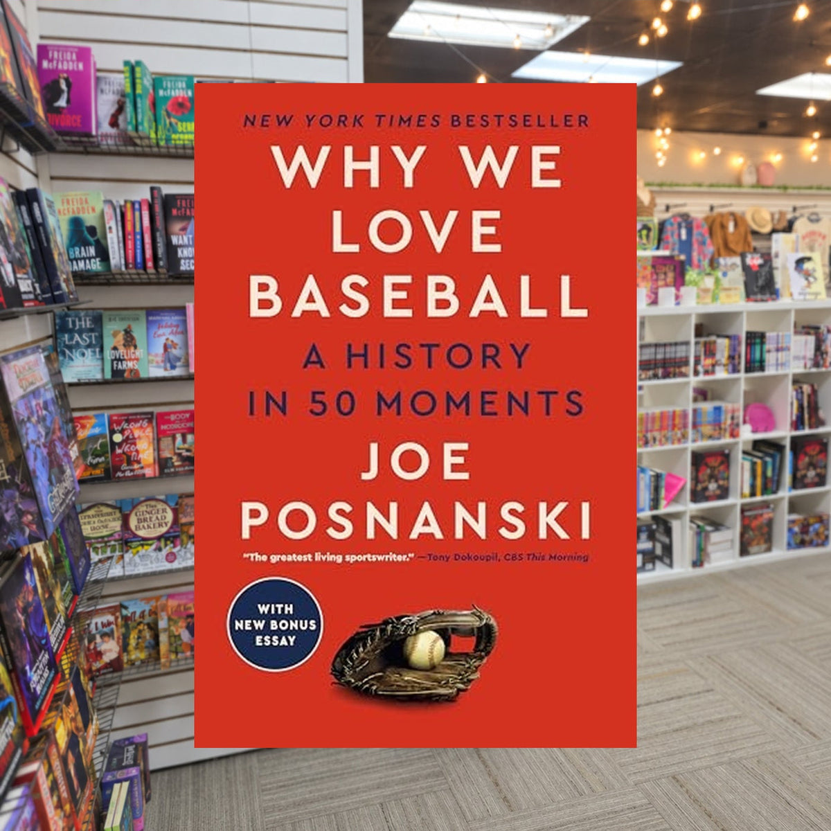 Why We Love Baseball: A History in 50 Moments by Joe Posnanski — actual cover on The Perk bookstore background