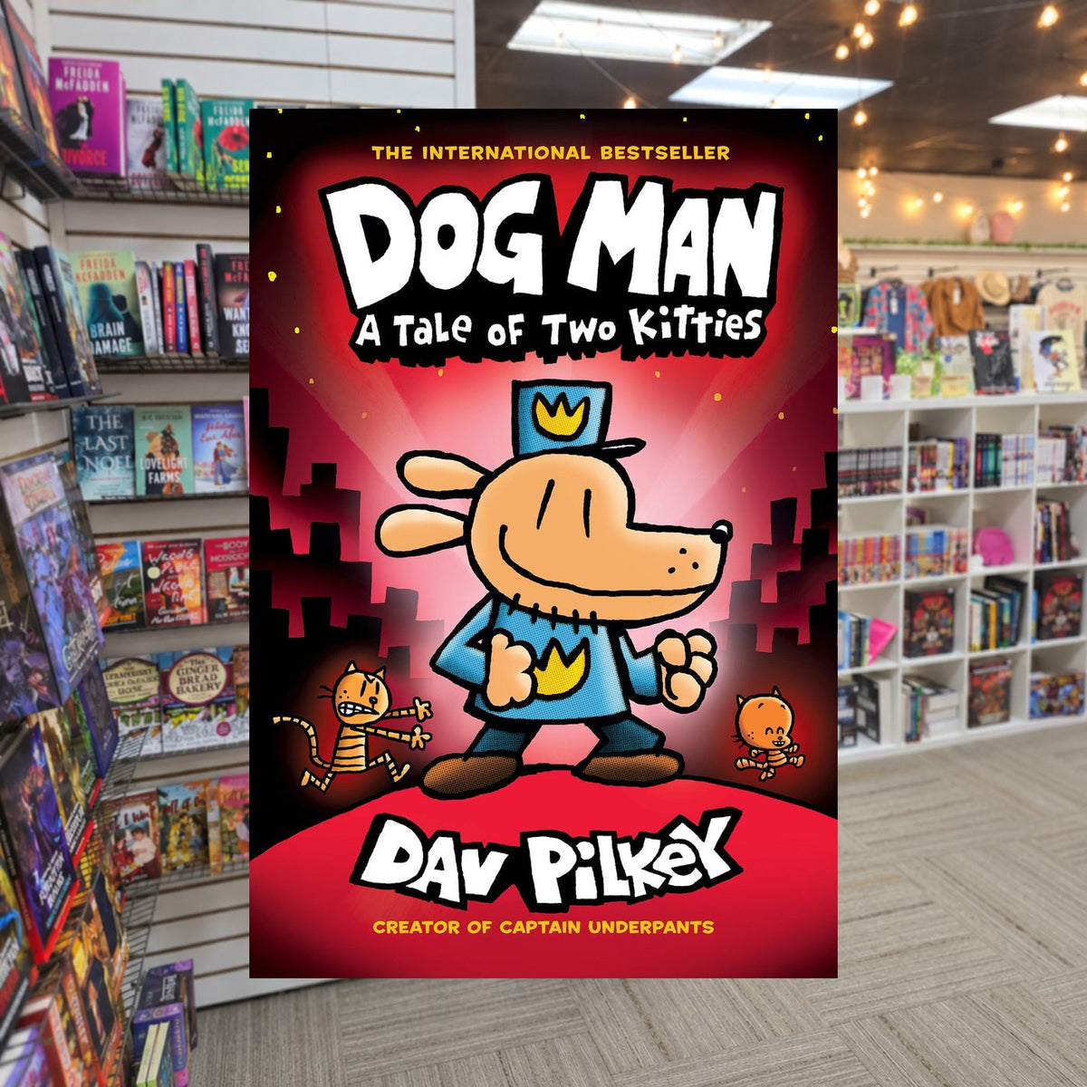 Dog Man: A Tale of Two Kitties by Dav Pilkey — actual cover on The Perk bookstore background