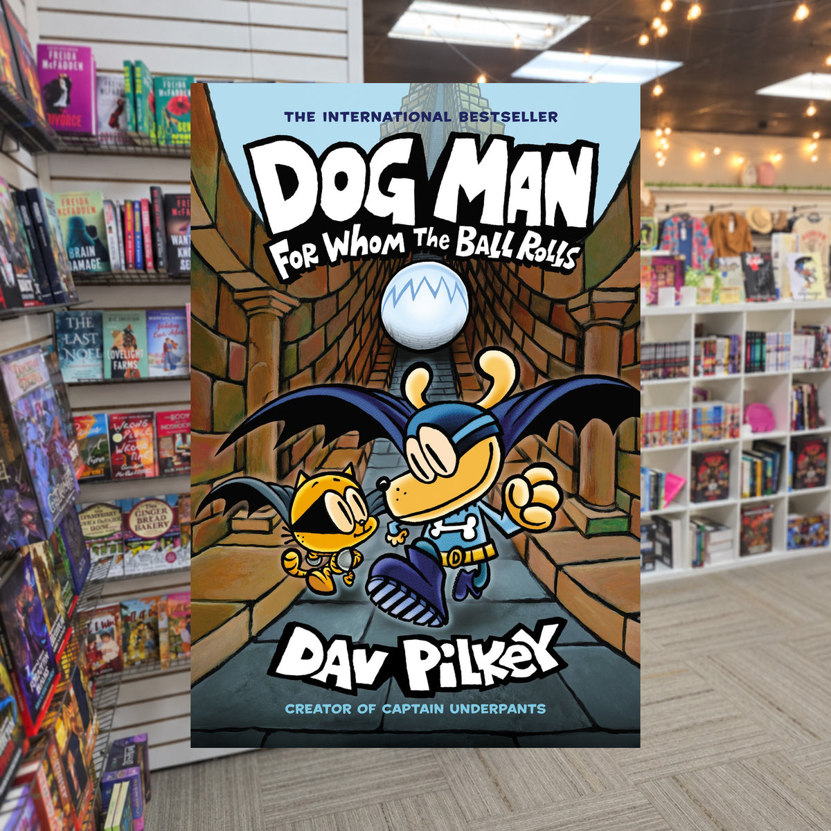 Dog Man: For Whom the Ball Rolls by Dav Pilkey — actual cover on The Perk bookstore background