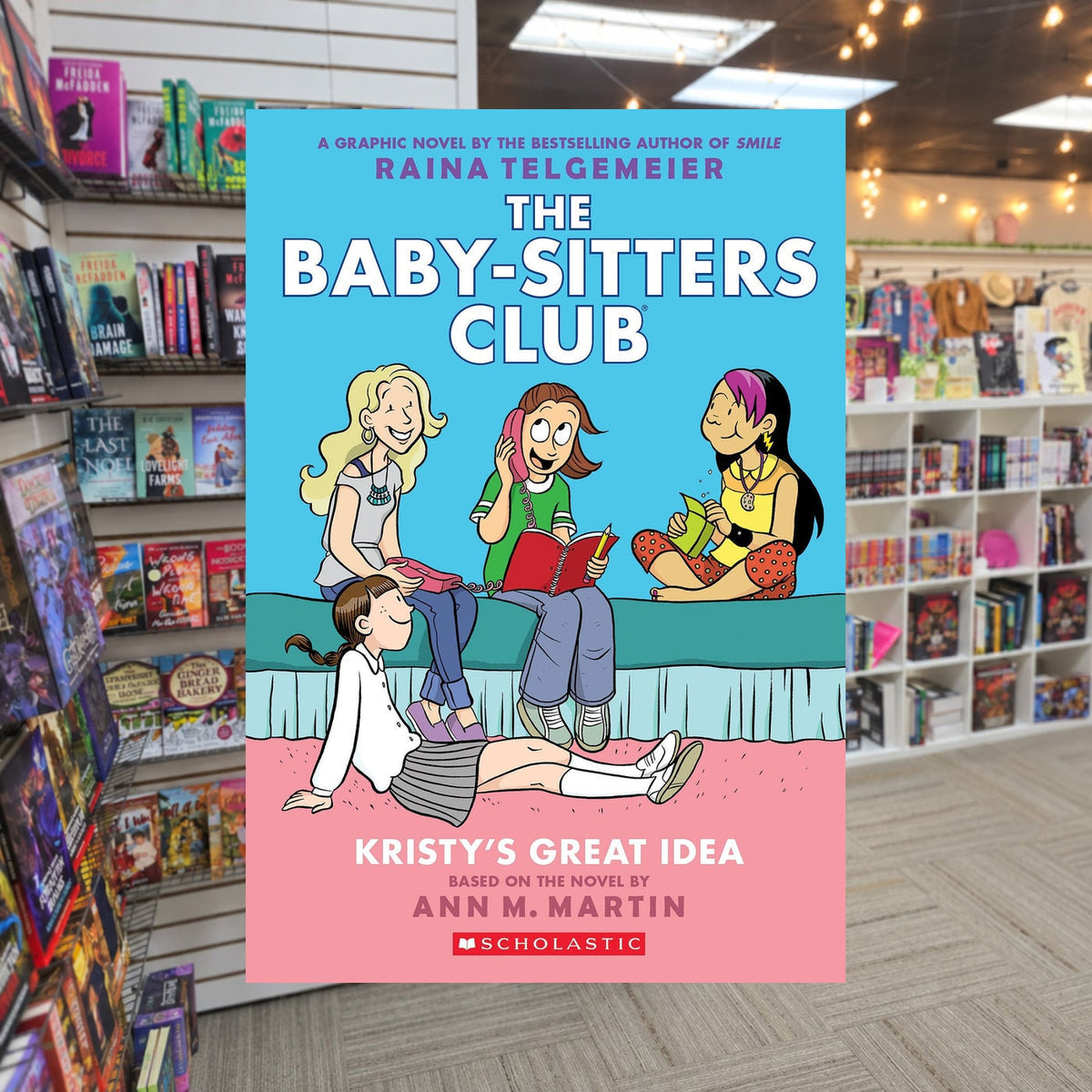 Kristy's Great Idea: A Graphic Novel (The Baby-Sitters Club #1) by Raina Telgemeier — actual cover on The Perk bookstore background