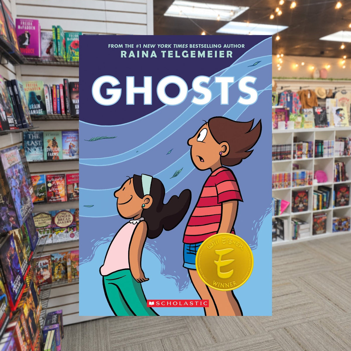 Ghosts: A Graphic Novel by Raina Telgemeier — actual cover on The Perk bookstore background