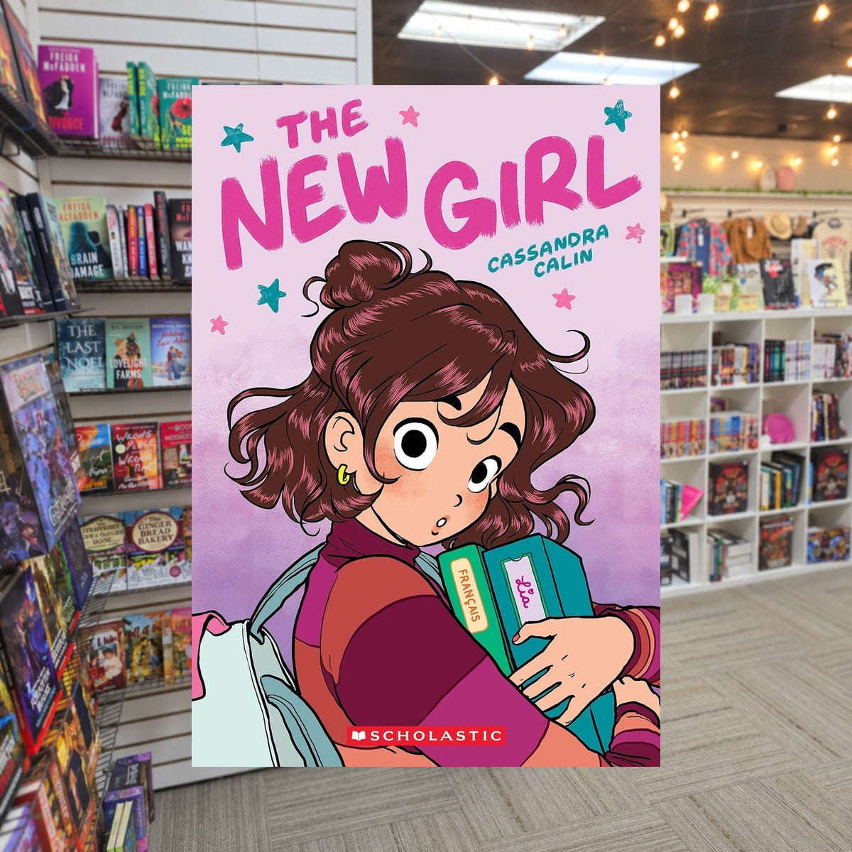 The New Girl by Cassandra Calin — actual cover on The Perk bookstore background