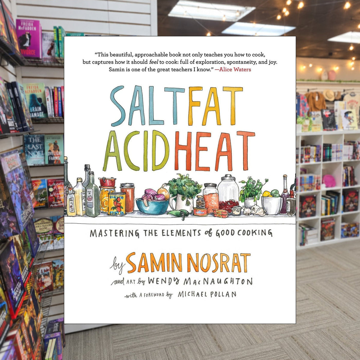 Salt, Fat, Acid, Heat: Mastering the elements of Good Cooking by Samin Nosrat — actual cover on The Perk bookstore background