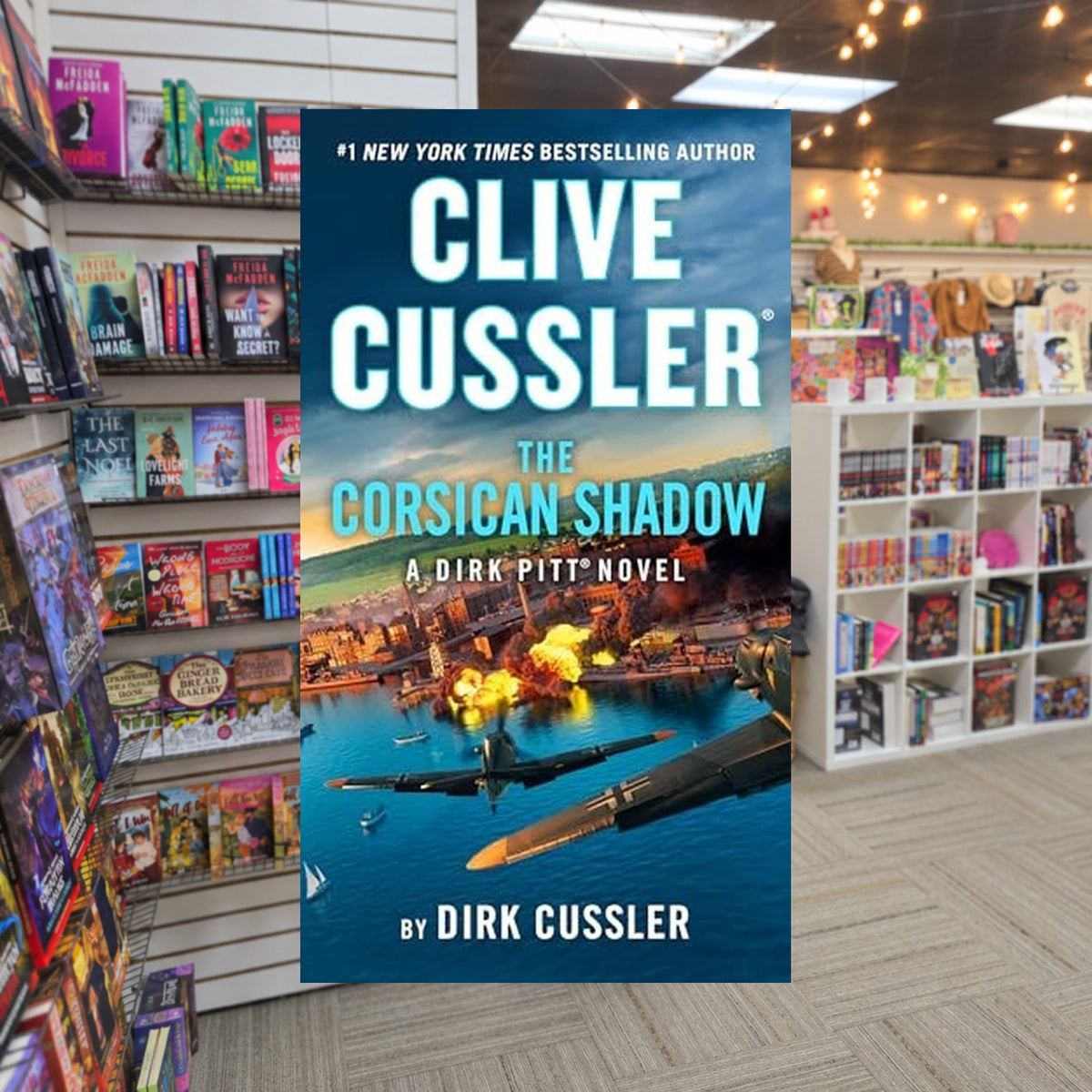 Dirk Pitt® #27: Clive Cussler The Corsican Shadow by Dirk Cussler — actual cover on The Perk bookstore background