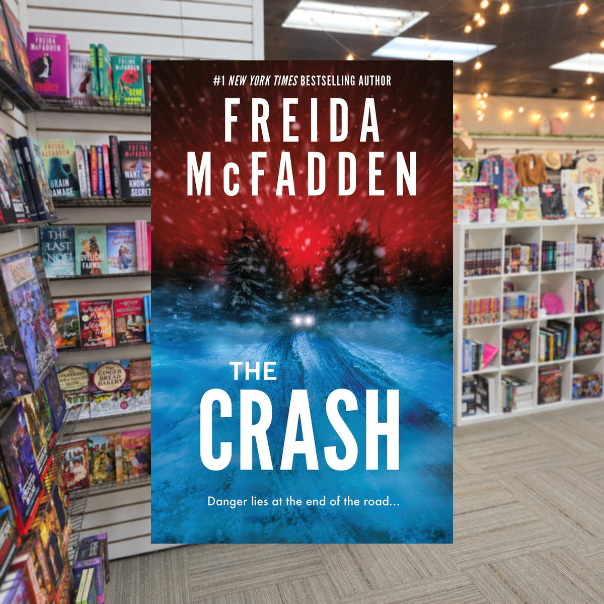 The Crash by Freida McFadden — actual cover on The Perk bookstore background