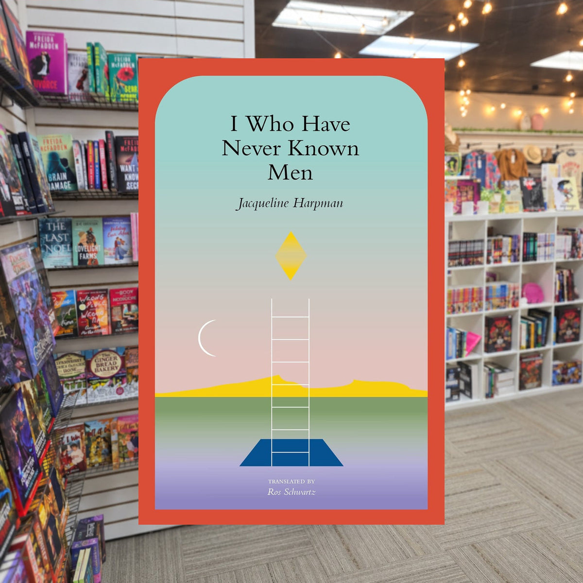 I Who Have Never Known Men by Jacqueline Harpman,  Ros Schwartz (Translator), Sophie Mackintosh (Afterword) — actual cover on The Perk bookstore background