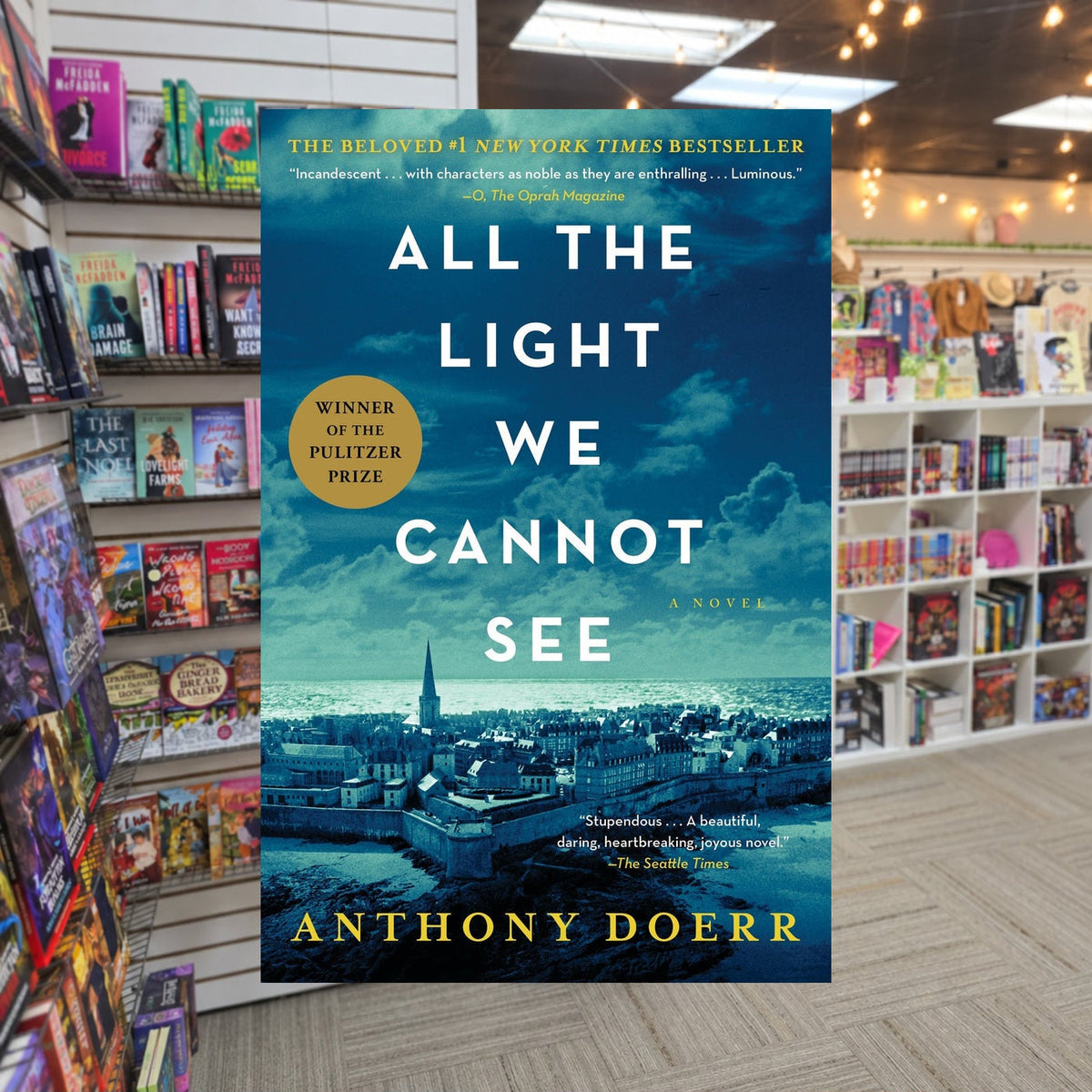 All the Light We Cannot See by Anthony Doerr — actual cover on The Perk bookstore background