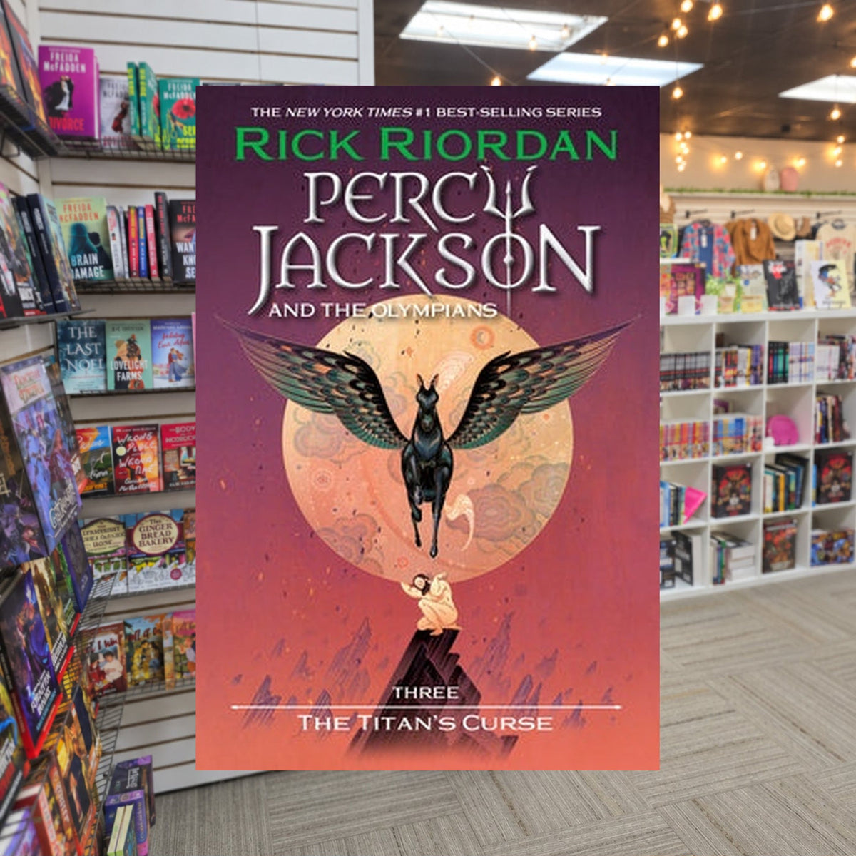 Percy Jackson and the Olympians #3 The Titan's Curse by Rick Riordan — actual cover on The Perk bookstore background
