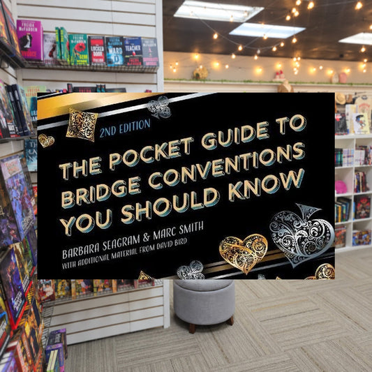 The Pocket Guide to Bridge Conventions You Should Know by Seagram Barbara — actual cover on The Perk bookstore background