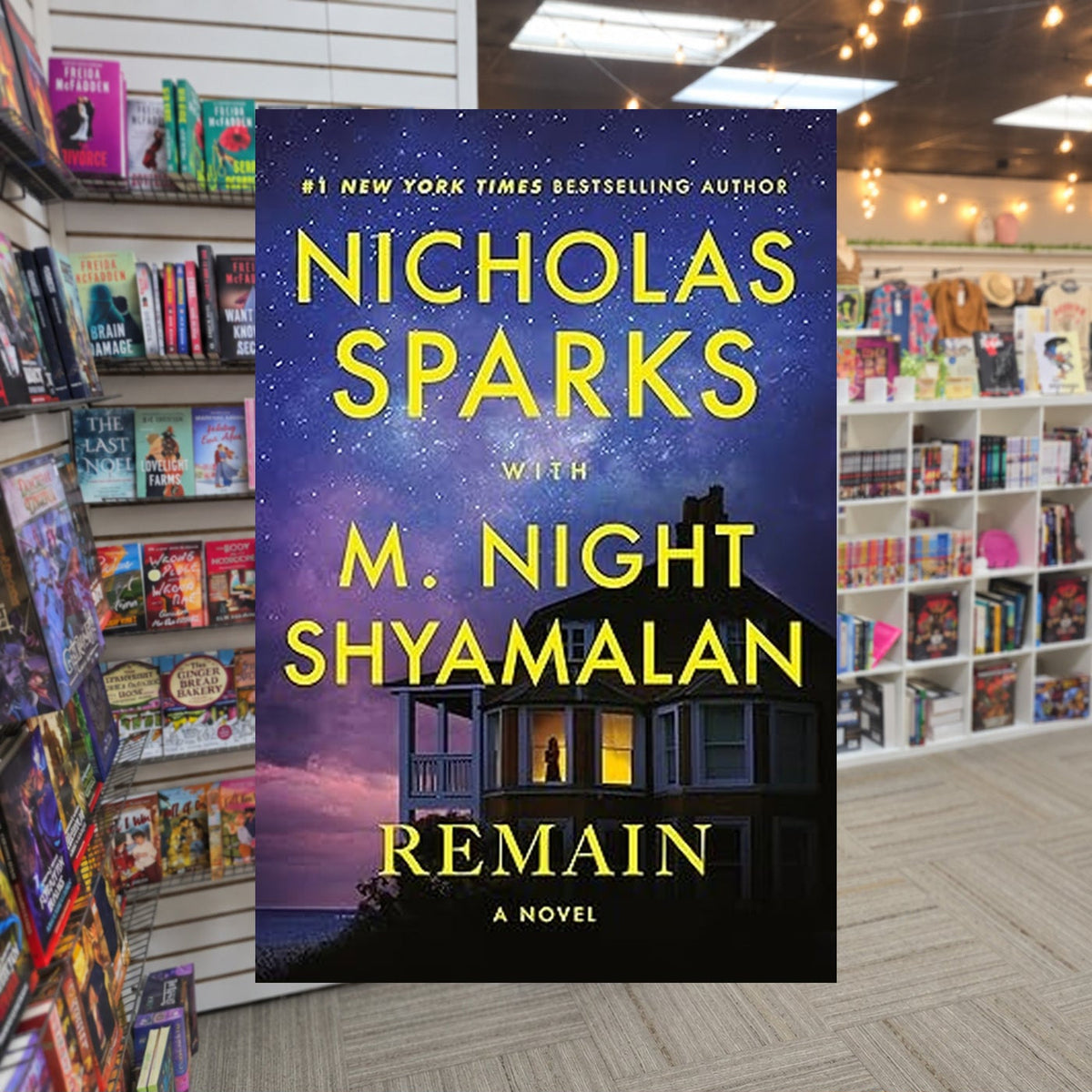 Remain by Nicholas Sparks and M. Night Shyamalan — actual cover on The Perk bookstore background