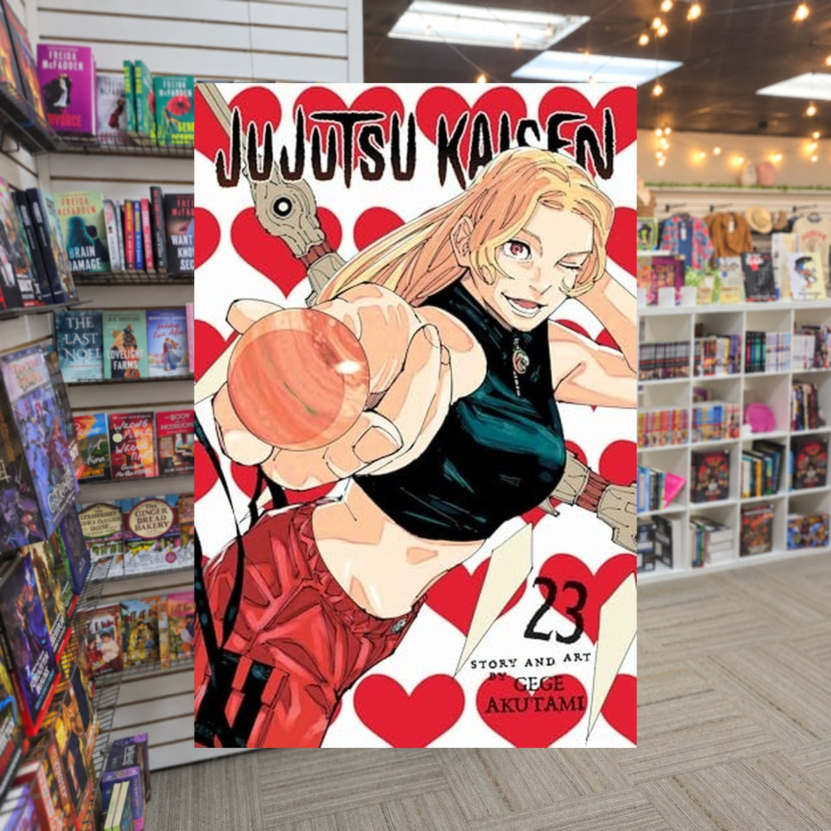 Jujutsu Kaisen vol 23 by Gege Akutami — actual cover on The Perk bookstore background